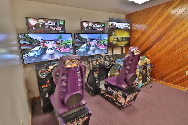 rec room featuring wood walls and carpet