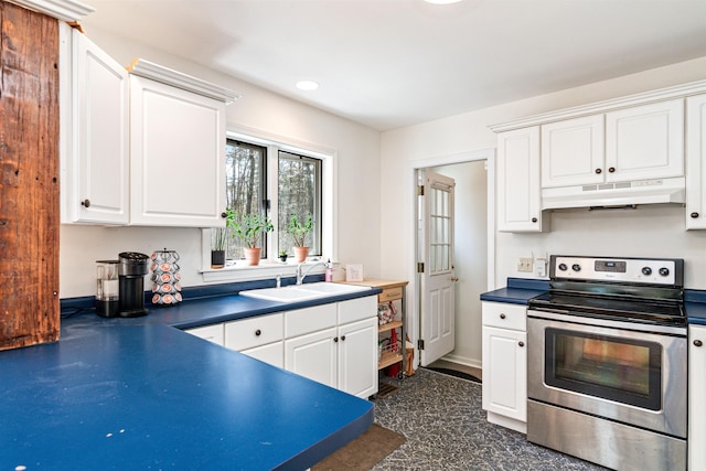 kitchen featuring dark countertops, under cabinet range hood, white cabinets, stainless steel electric stove, and a sink