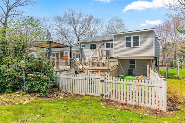 rear view of property featuring stairs, a fenced backyard, a yard, and a deck