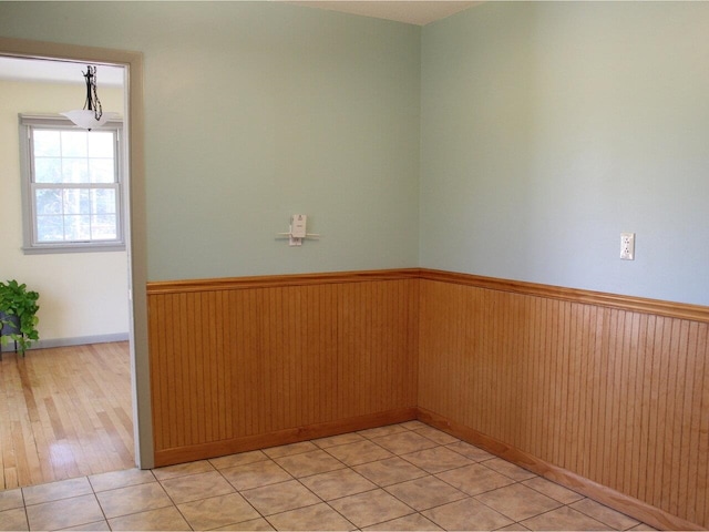 spare room with a wainscoted wall