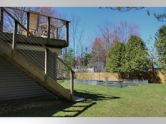 view of yard with fence and stairway