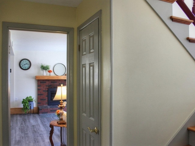 hall with stairway, baseboards, and wood finished floors