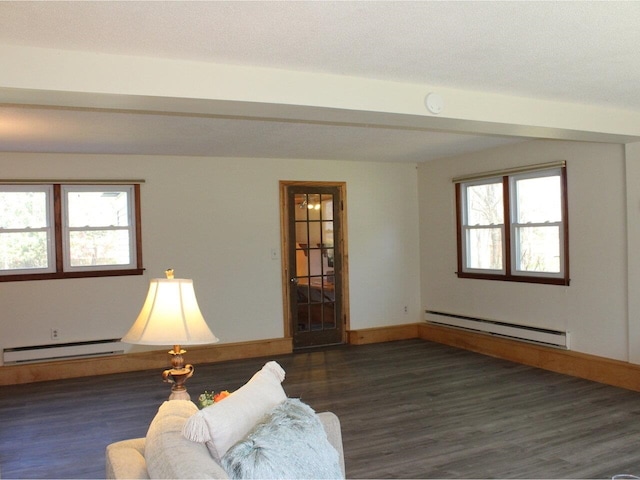 sitting room with baseboards, baseboard heating, and wood finished floors