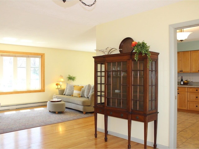 living area featuring a baseboard radiator and light wood-style flooring