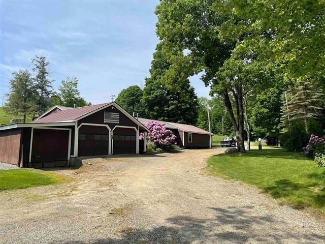 garage with dirt driveway