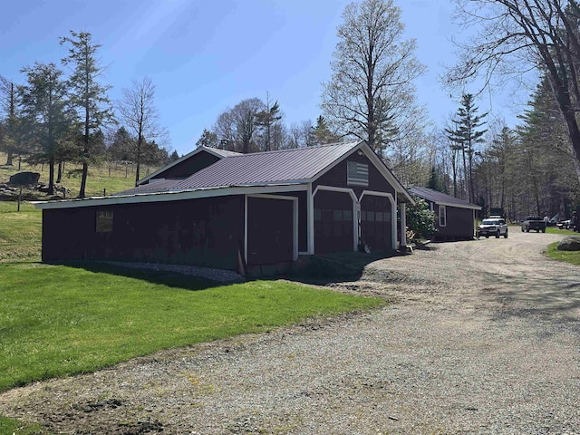 detached garage featuring dirt driveway