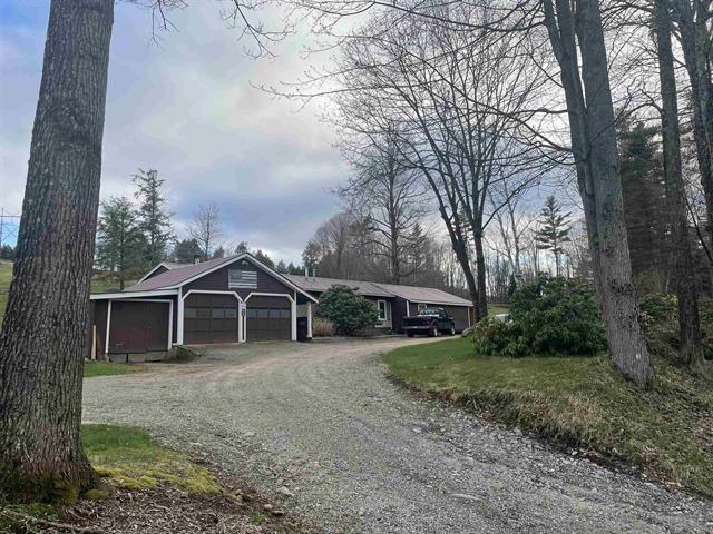view of front of house featuring a garage and dirt driveway