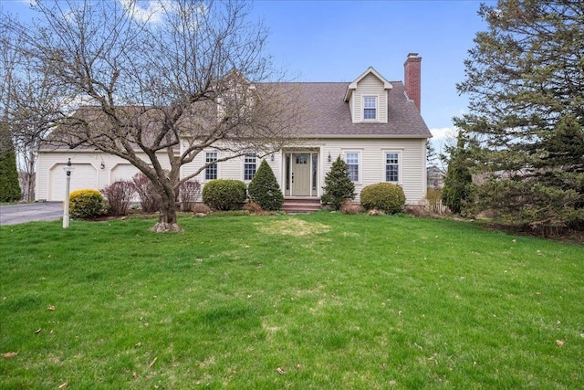 cape cod house with a garage, driveway, a chimney, and a front lawn