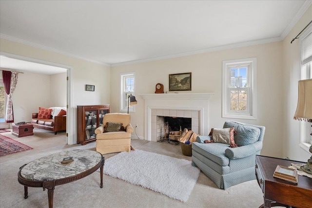 carpeted living area featuring a tiled fireplace, ornamental molding, and a wealth of natural light