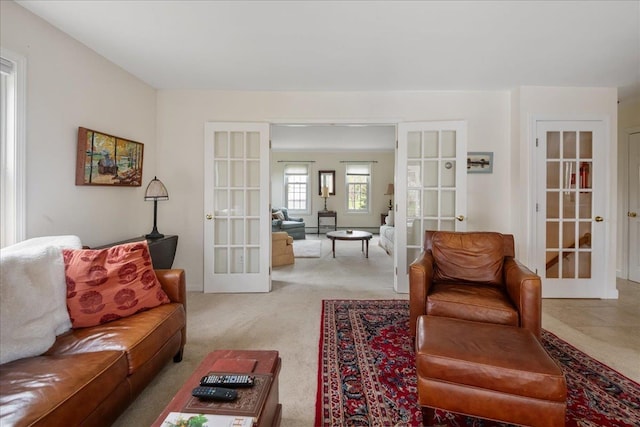 living area featuring light carpet and french doors