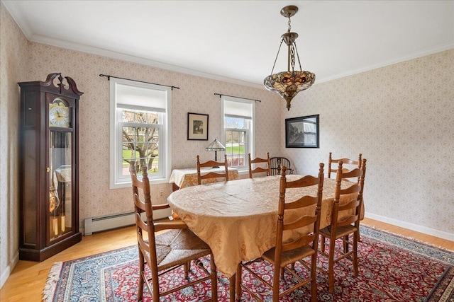 dining space featuring wallpapered walls, ornamental molding, light wood finished floors, and a baseboard radiator