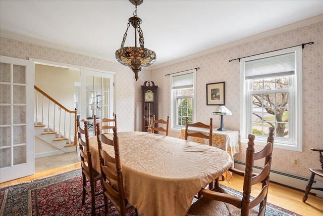 dining area featuring crown molding, stairway, light wood-type flooring, and wallpapered walls