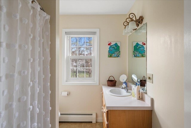 bathroom featuring vanity, baseboards, and baseboard heating