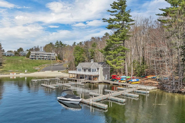 dock area featuring a water view and a forest view