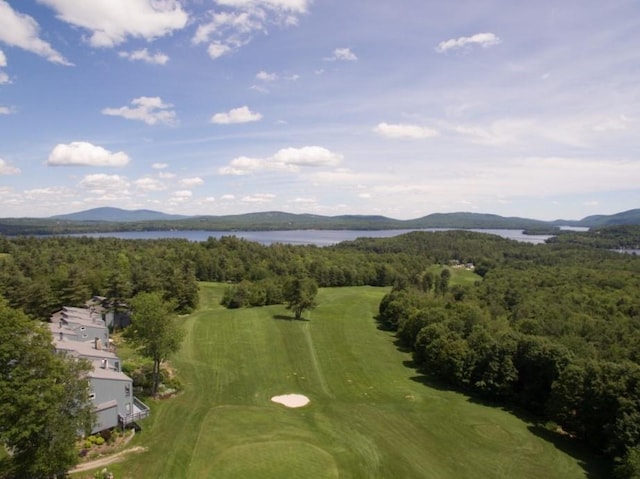 bird's eye view featuring golf course view, a water and mountain view, and a forest view