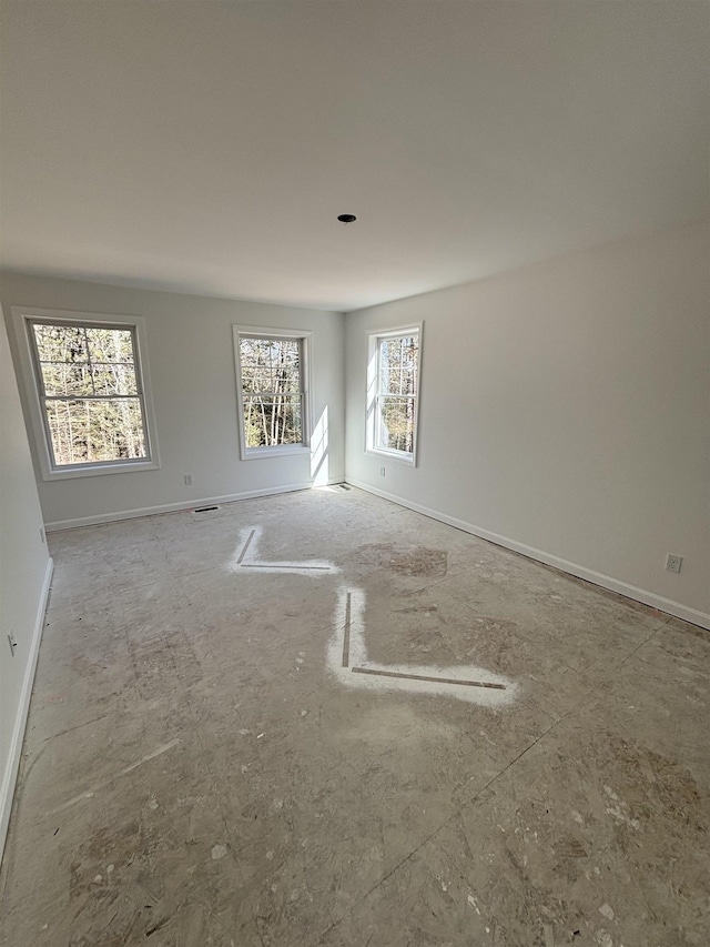 empty room featuring baseboards