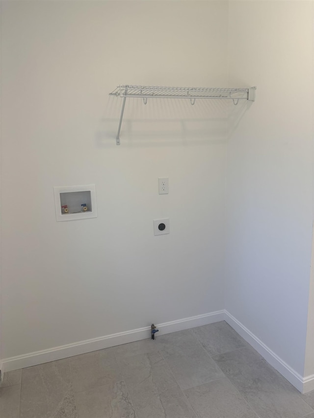 washroom with baseboards, hookup for a washing machine, hookup for an electric dryer, and laundry area