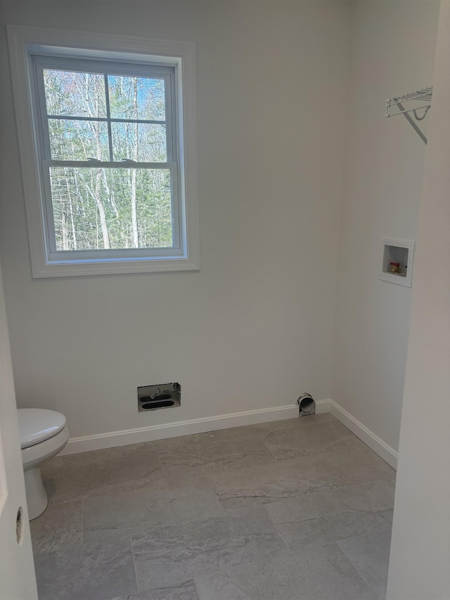 laundry room with baseboards, washer hookup, and laundry area