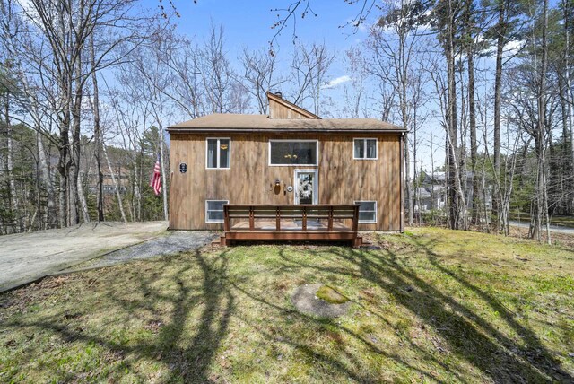 rear view of house featuring a yard and a deck