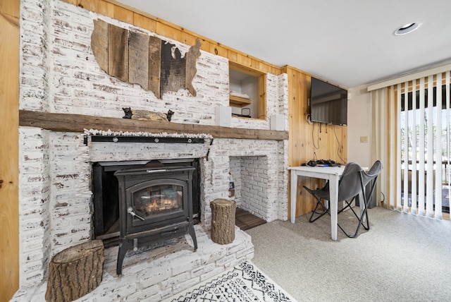 living room with carpet flooring and a wood stove