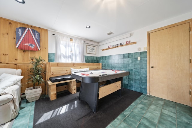 rec room featuring tile walls, wainscoting, and visible vents