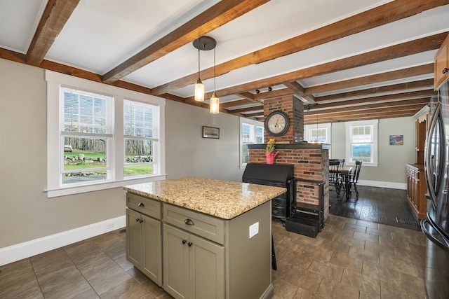 104 Pease Rd, Meredith, NH 03253 - kitchen featuring light stone counters, a center island, freestanding refrigerator, baseboards, and gray cabinetry