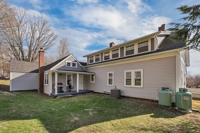 104 Pease Rd, Meredith, NH 03253 - rear view of property with covered porch, a yard, a chimney, and cooling unit