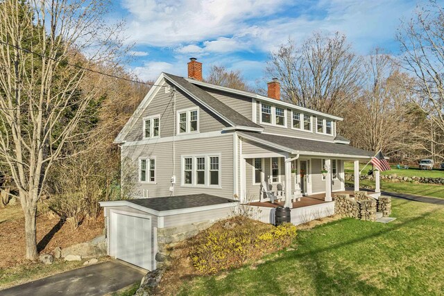 104 Pease Rd, Meredith, NH 03253 - view of front of property with a front lawn, a garage, a chimney, covered porch, and driveway