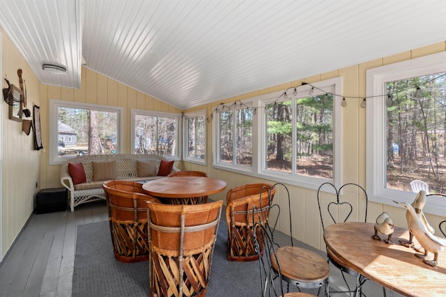 sunroom with wood-type flooring and lofted ceiling