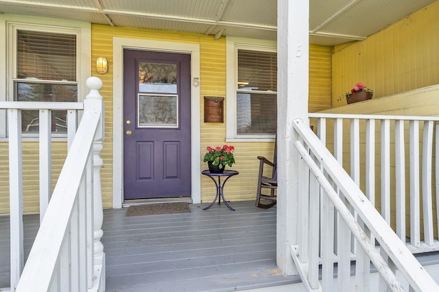 view of exterior entry featuring a porch