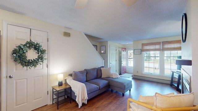 living area with baseboard heating and wood finished floors