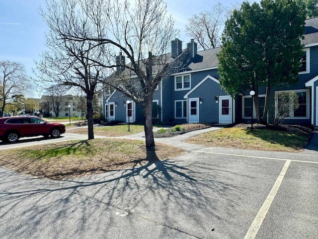 exterior space with a front yard and a chimney