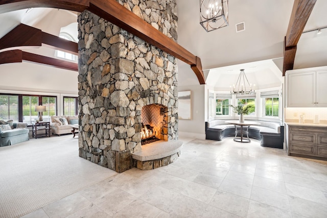 details featuring arched walkways, visible vents, a fireplace, and a notable chandelier