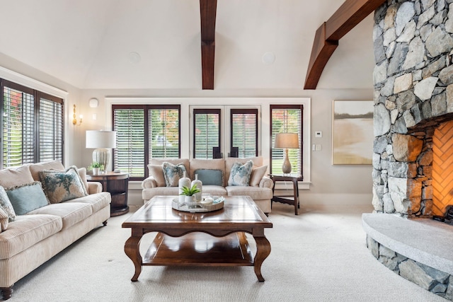 carpeted living area featuring baseboards, a wealth of natural light, and vaulted ceiling with beams