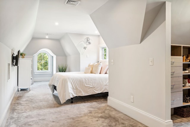 carpeted bedroom featuring visible vents, baseboards, and lofted ceiling