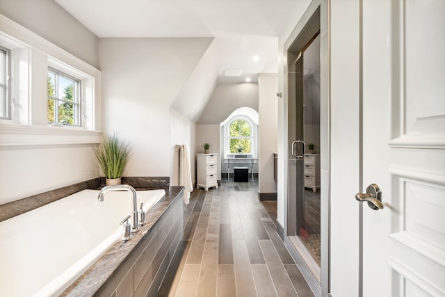 bathroom with a stall shower, recessed lighting, a bath, and lofted ceiling