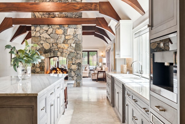 bar with vaulted ceiling with beams and a sink