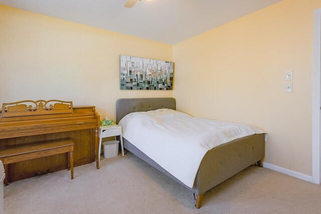 carpeted bedroom with baseboards and a ceiling fan