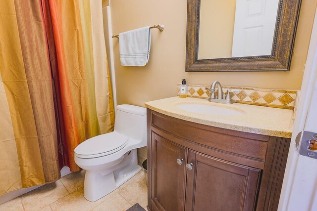 bathroom featuring tile patterned floors, vanity, and toilet