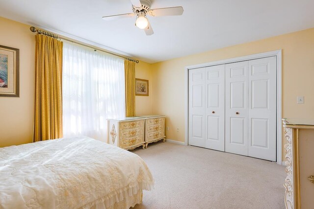carpeted bedroom with a closet and ceiling fan