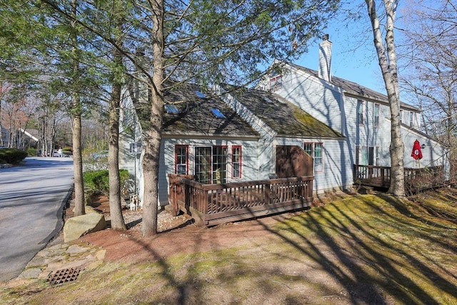 exterior space featuring a deck and a chimney