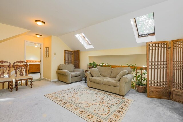 living room featuring light carpet, lofted ceiling with skylight, and plenty of natural light