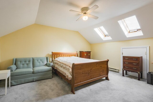 bedroom with a ceiling fan, lofted ceiling with skylight, and light carpet