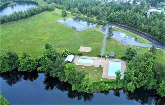 birds eye view of property with a water view