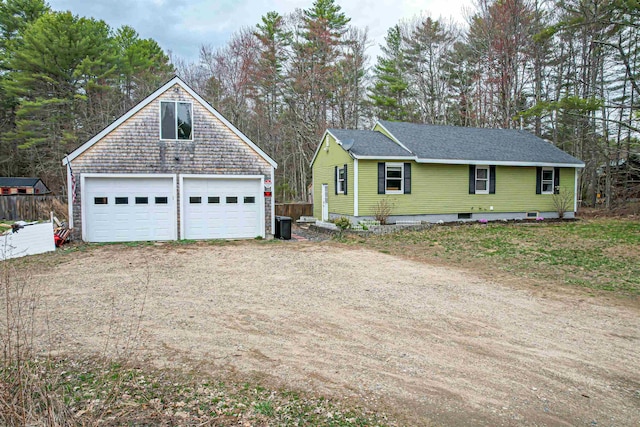 exterior space featuring a garage and an outdoor structure