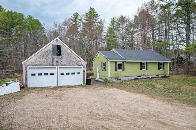 view of front facade with an outdoor structure, a garage, and roof with shingles