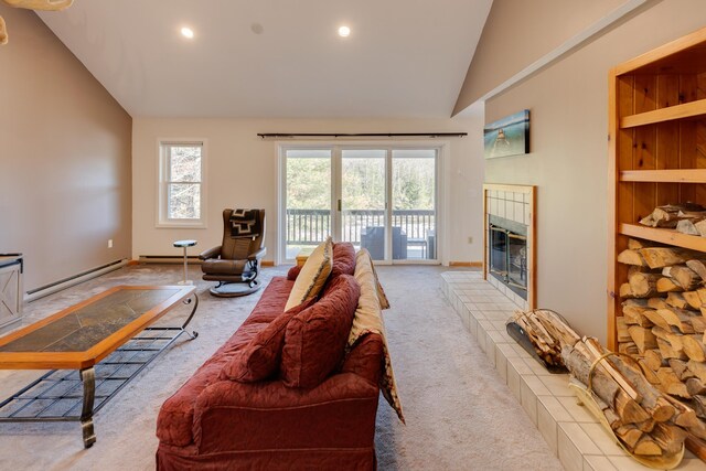 carpeted living area with a tiled fireplace, a baseboard radiator, high vaulted ceiling, and recessed lighting