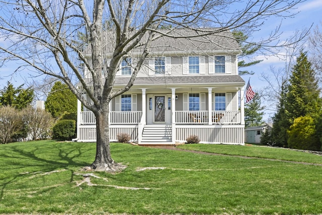 view of front facade with roof with shingles, covered porch, and a front yard