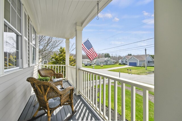 balcony featuring covered porch and a residential view