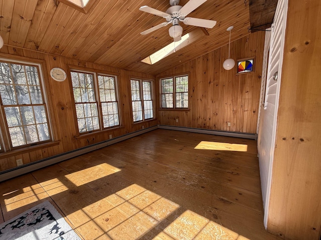 unfurnished sunroom with a skylight, baseboard heating, and french doors